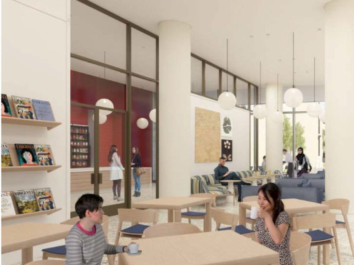 The image shows a modern cafe interior with people sitting at tables, having drinks. There are bookshelves, tall windows, and hanging lights.